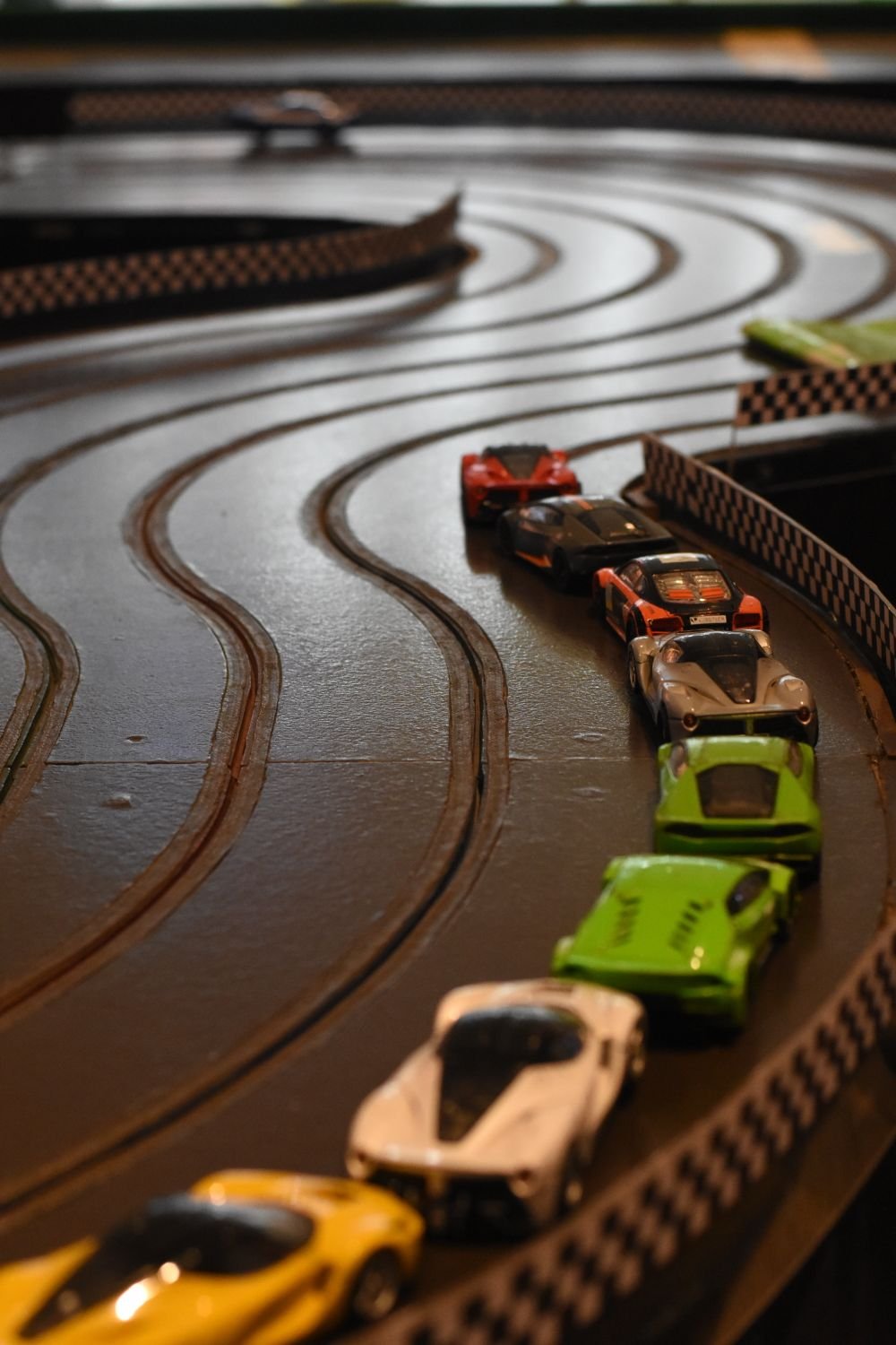 Diecast toy cars arranged on a toy road